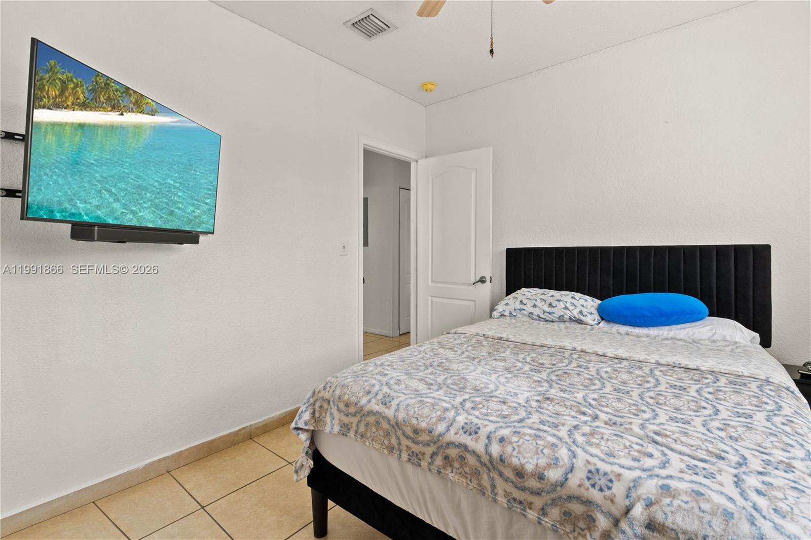 317 East 3rd Street, Unit 201 Hialeah, FL 33010 - Photo 13 of 50 a bedroom with a bed and a view of kitchen