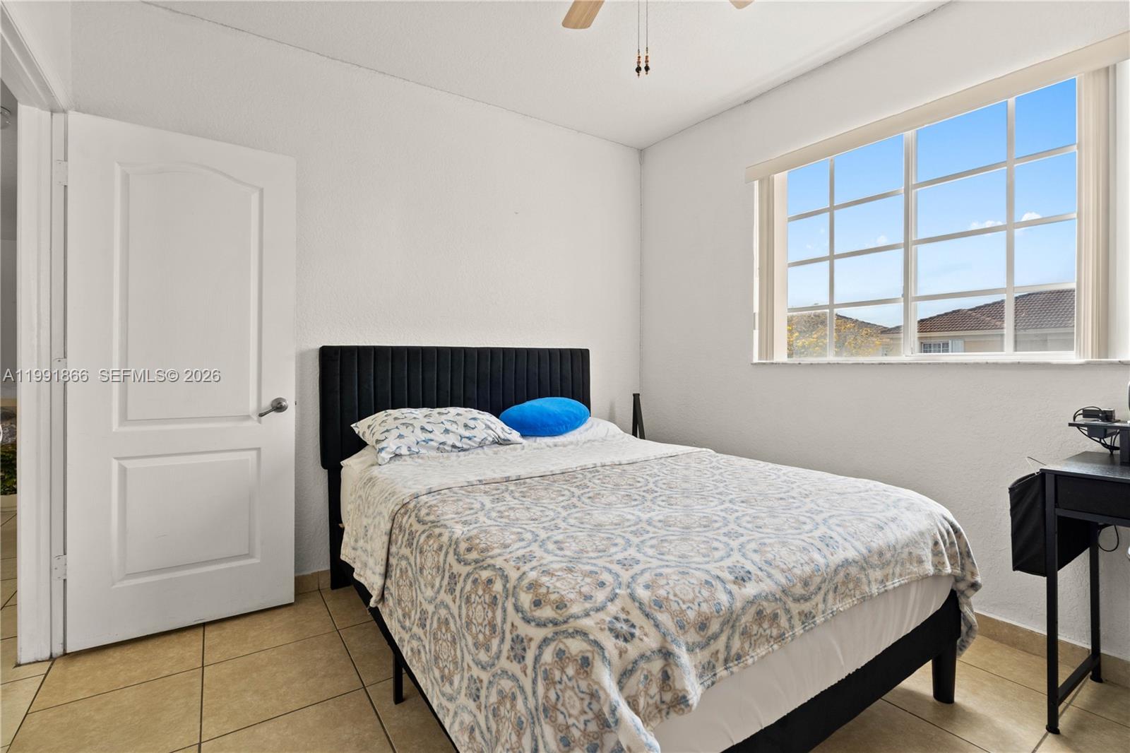 317 East 3rd Street, Unit 201 Hialeah, FL 33010 - Photo 14 of 50 a bedroom with a bed and window