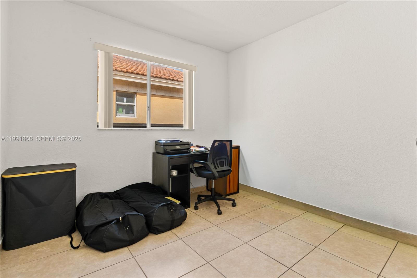 317 East 3rd Street, Unit 201 Hialeah, FL 33010 - Photo 18 of 50 a room with a chair and a window