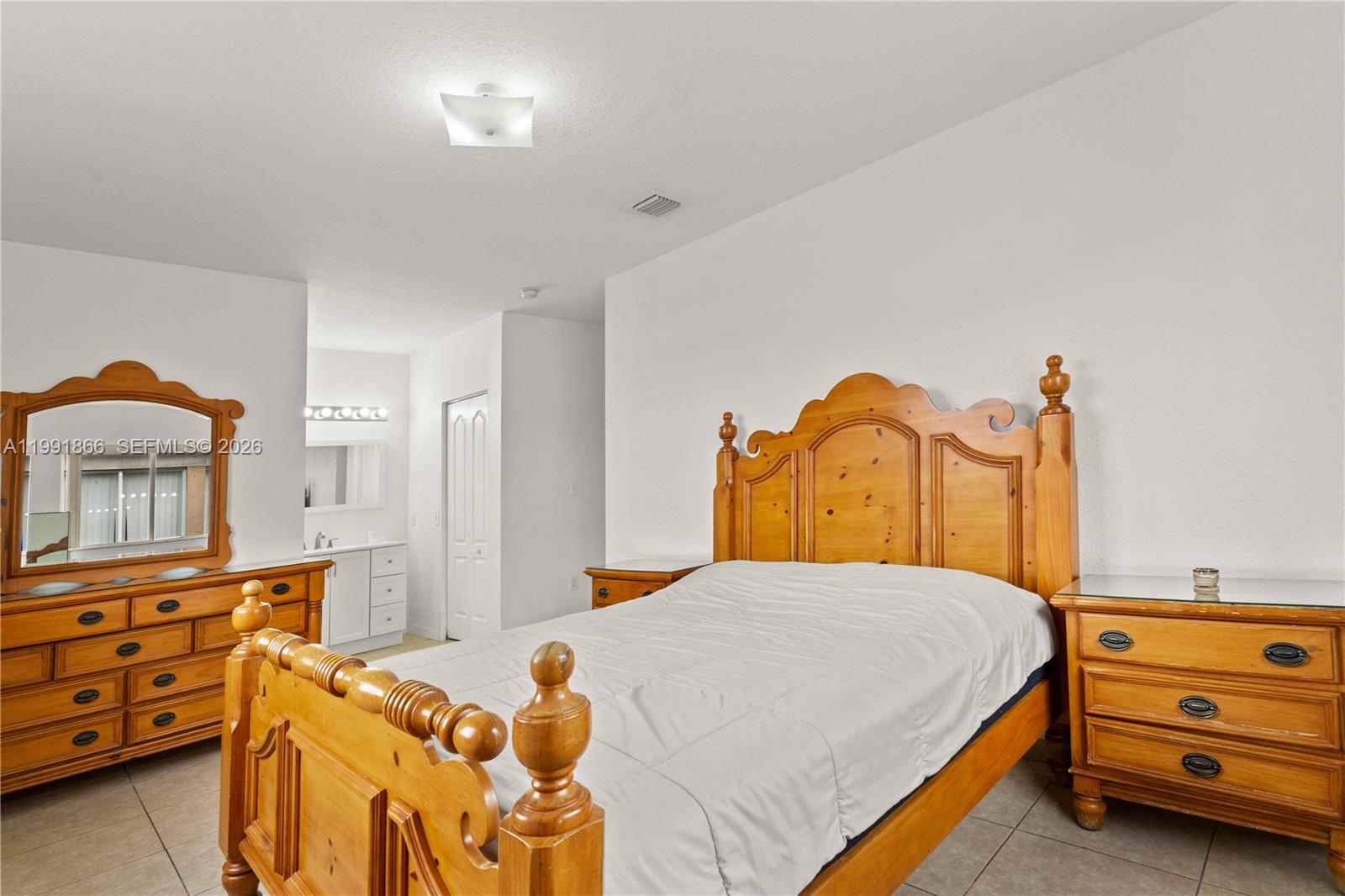 317 East 3rd Street, Unit 201 Hialeah, FL 33010 - Photo 20 of 50 a bedroom with a bed and a dresser