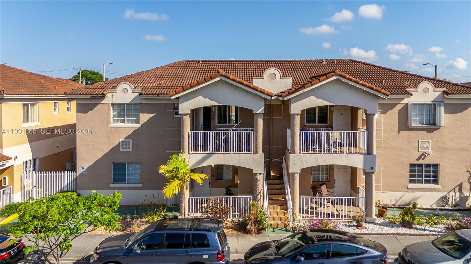 317 East 3rd Street, Unit 201 Hialeah, FL 33010 - Photo 2 of 50 a front view of a house with a garden