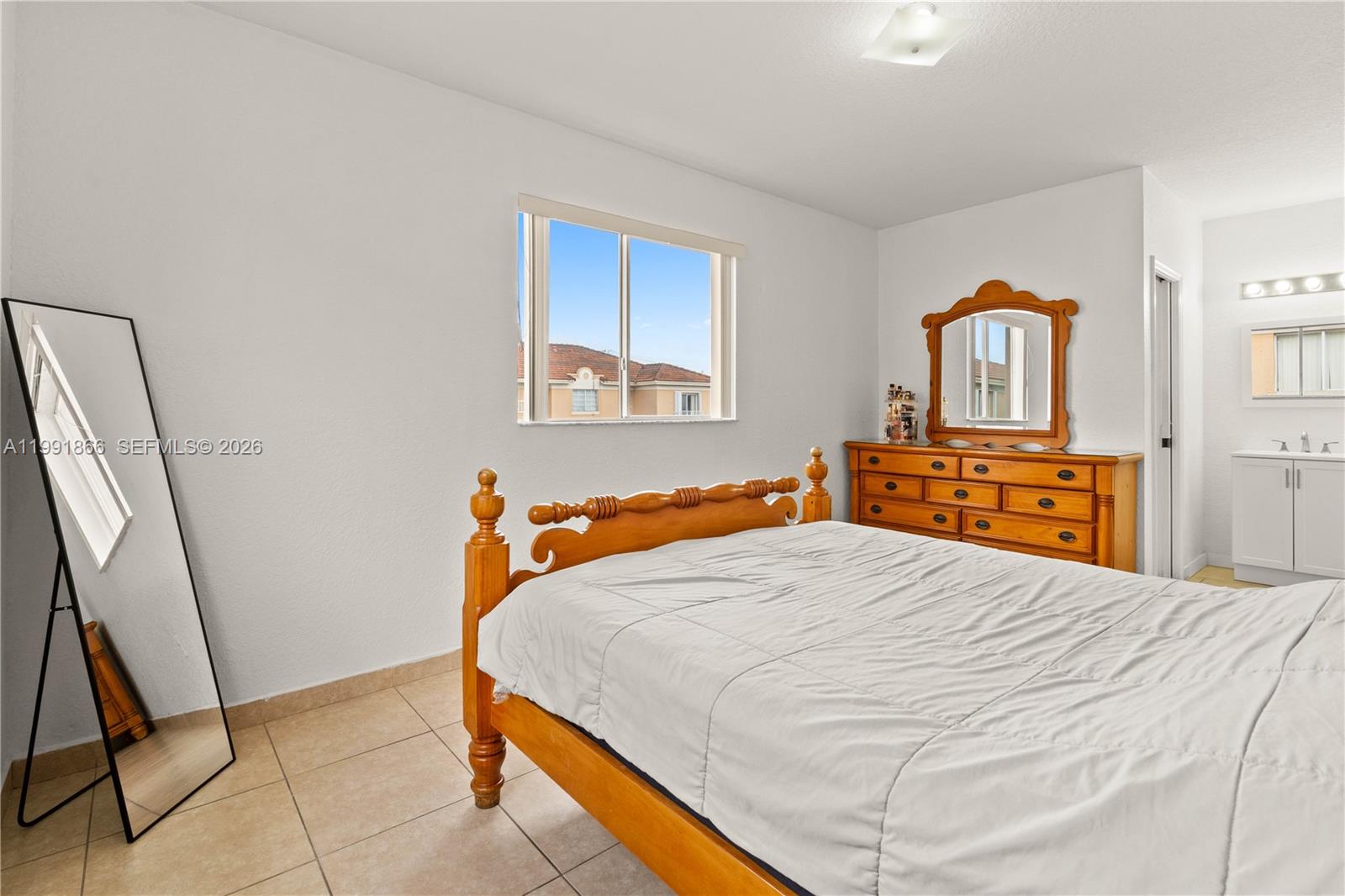 317 East 3rd Street, Unit 201 Hialeah, FL 33010 - Photo 21 of 50 a bedroom with a bed and a dresser