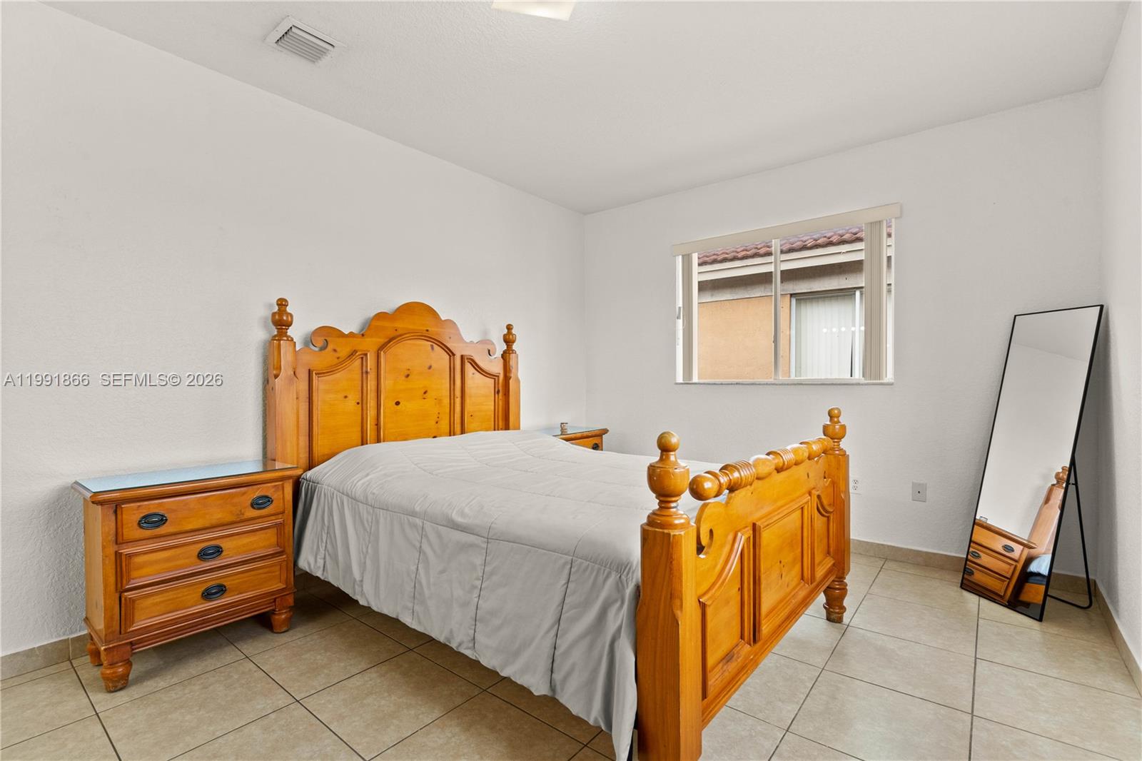 317 East 3rd Street, Unit 201 Hialeah, FL 33010 - Photo 22 of 50 a bedroom with a bed and wooden floor