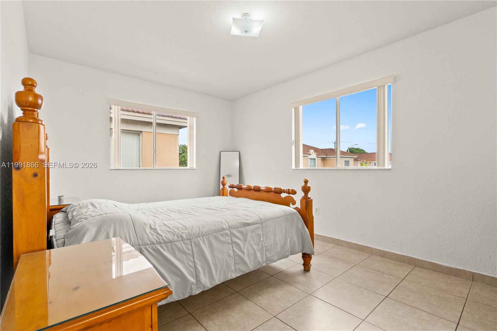 317 East 3rd Street, Unit 201 Hialeah, FL 33010 - Photo 23 of 50 a bedroom with a bed and a window