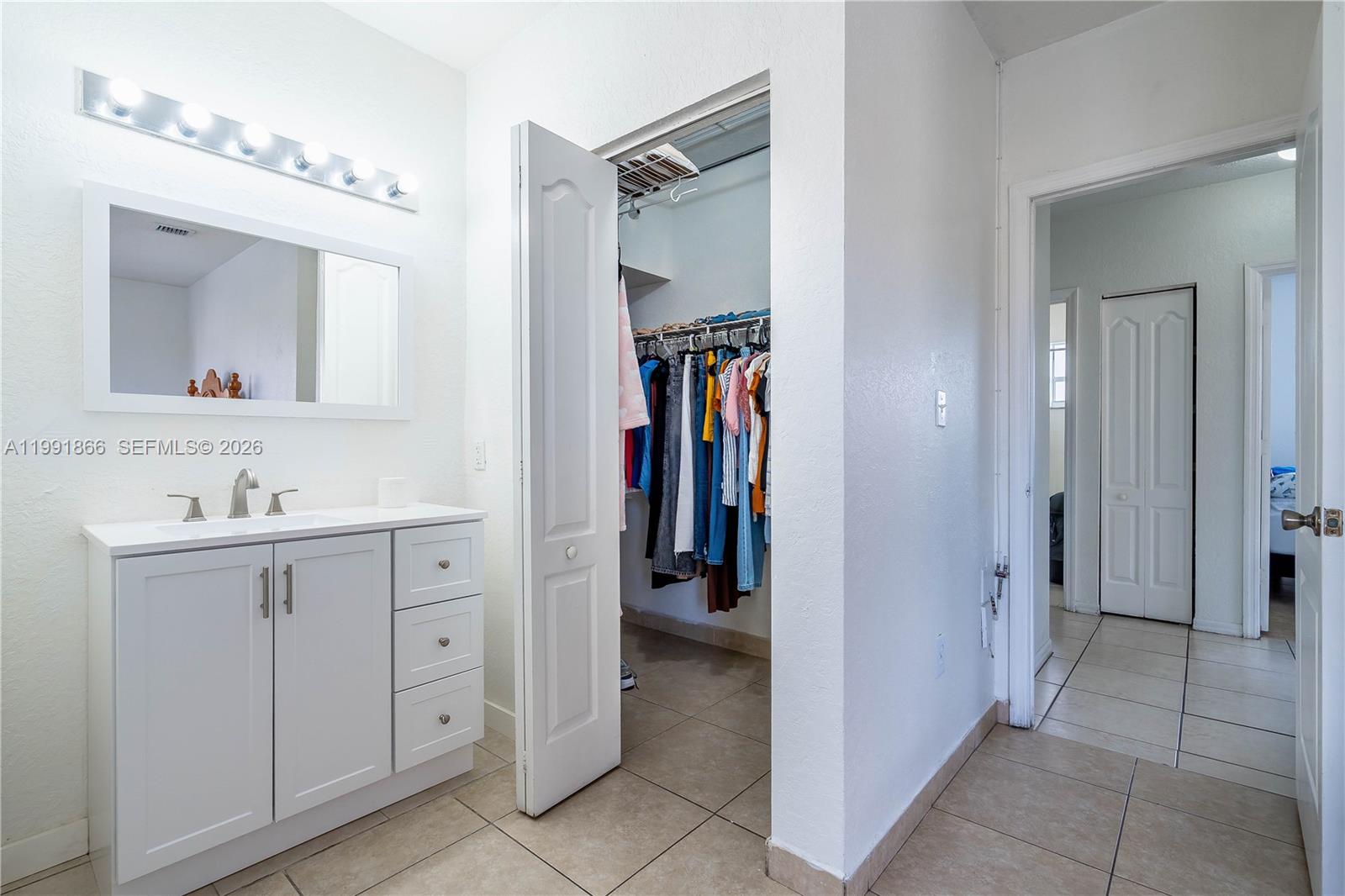 317 East 3rd Street, Unit 201 Hialeah, FL 33010 - Photo 24 of 50 a bathroom with a double vanity sink and a mirror