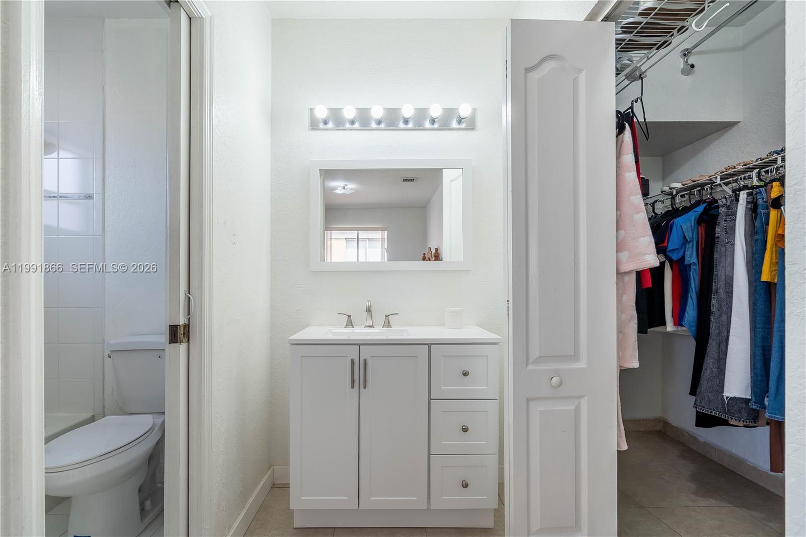 317 East 3rd Street, Unit 201 Hialeah, FL 33010 - Photo 26 of 50 a bathroom with a sink a toilet and a mirror