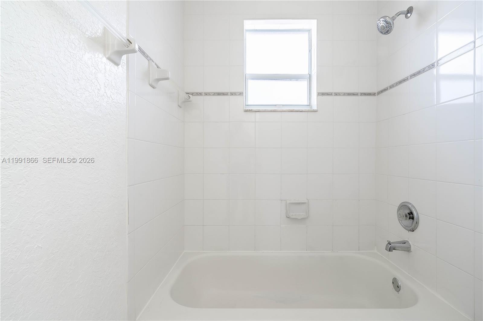 317 East 3rd Street, Unit 201 Hialeah, FL 33010 - Photo 27 of 50 a close up of a bathtub curtain
