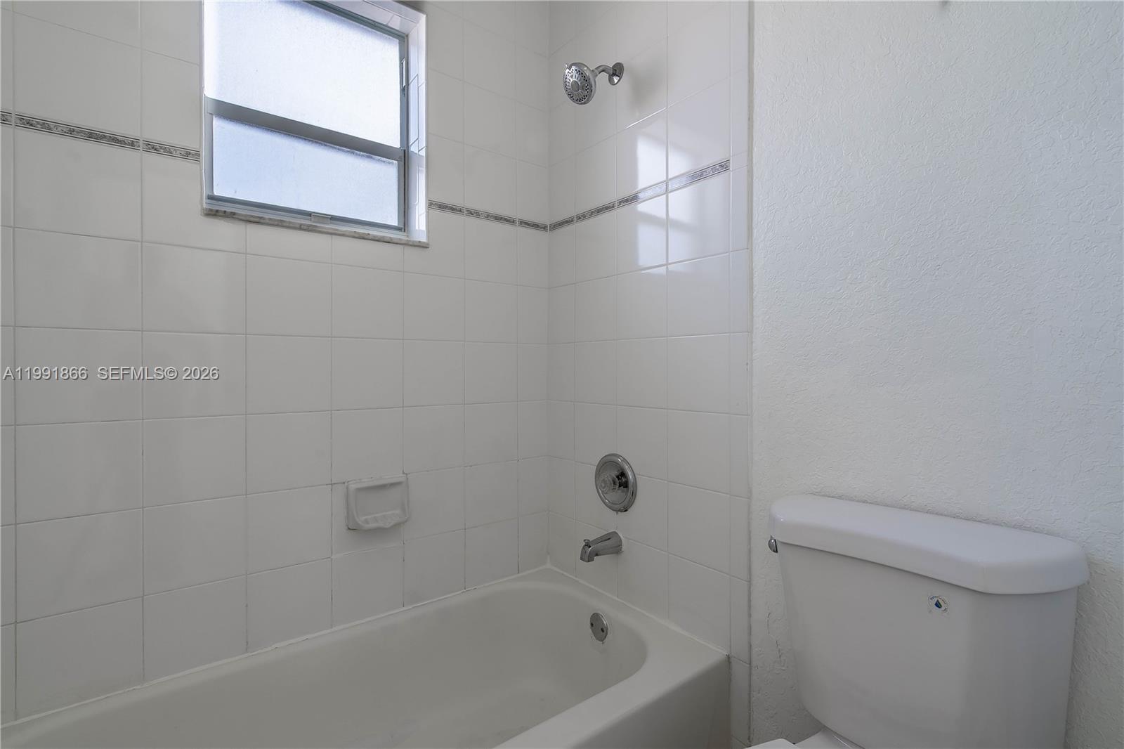 317 East 3rd Street, Unit 201 Hialeah, FL 33010 - Photo 29 of 50 a bathroom with a bathtub and a toilet