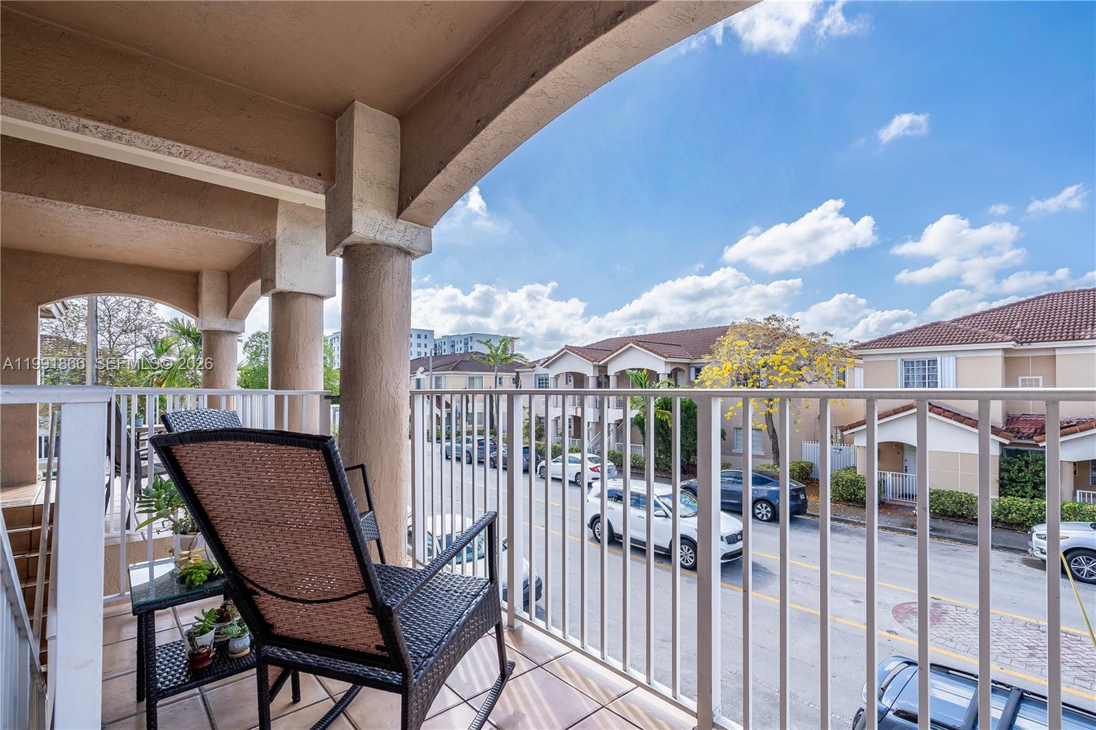 317 East 3rd Street, Unit 201 Hialeah, FL 33010 - Photo 38 of 50 a view of a chair and tables in the balcony