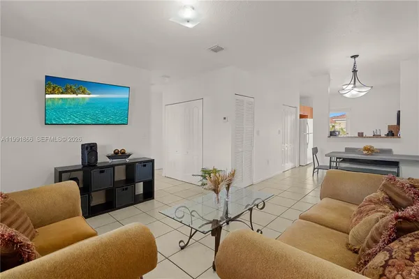 a living room with furniture a rug and a painting