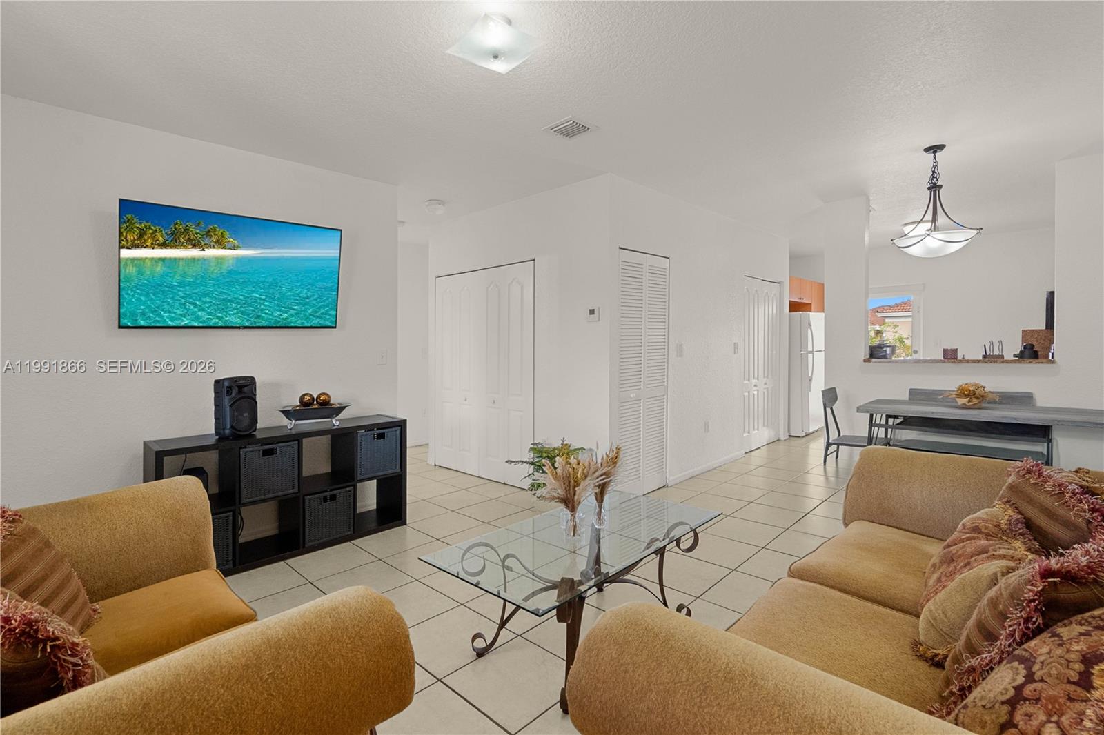 317 East 3rd Street, Unit 201 Hialeah, FL 33010 - Photo 4 of 50 a living room with furniture a rug and a painting