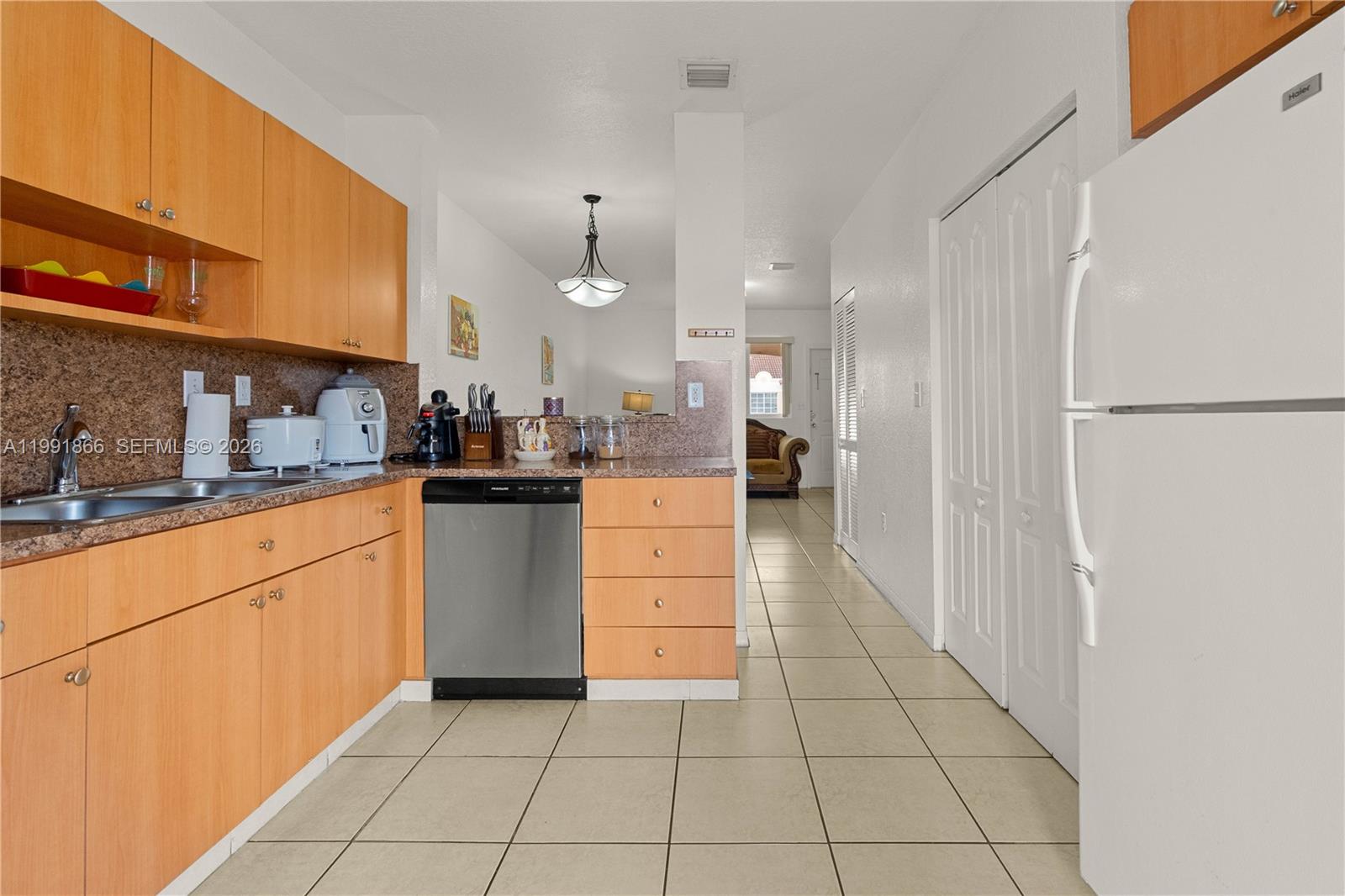 317 East 3rd Street, Unit 201 Hialeah, FL 33010 - Photo 10 of 50 a kitchen with stainless steel appliances granite countertop a refrigerator and a sink