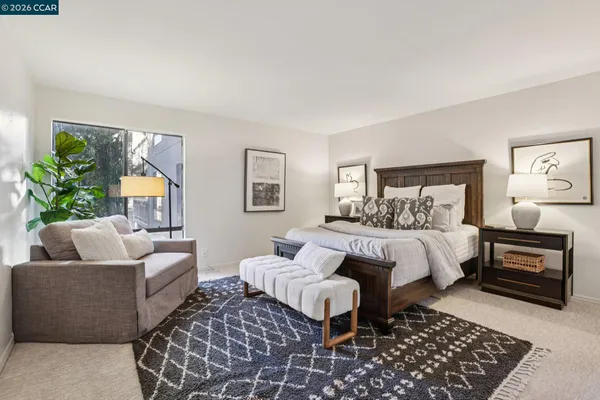 a bedroom with a bed and a couch