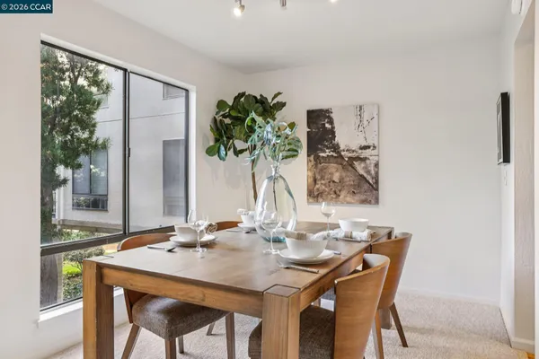 a dining room with furniture and wooden floor