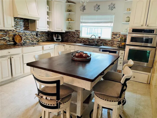 a kitchen with dining table and chairs