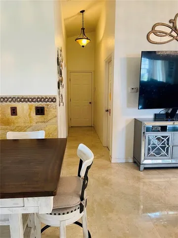 a view of a living room with furniture and flat screen tv