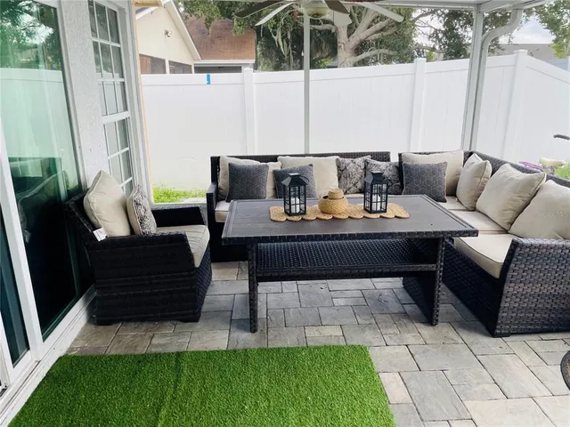 a living room with furniture a window and gym equipment
