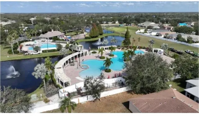 an aerial view of a house with a swimming pool yard and outdoor seating