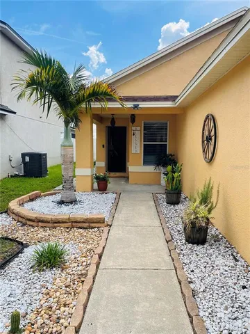 a view of a house with potted plants