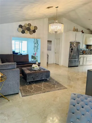 a living room with furniture and a chandelier