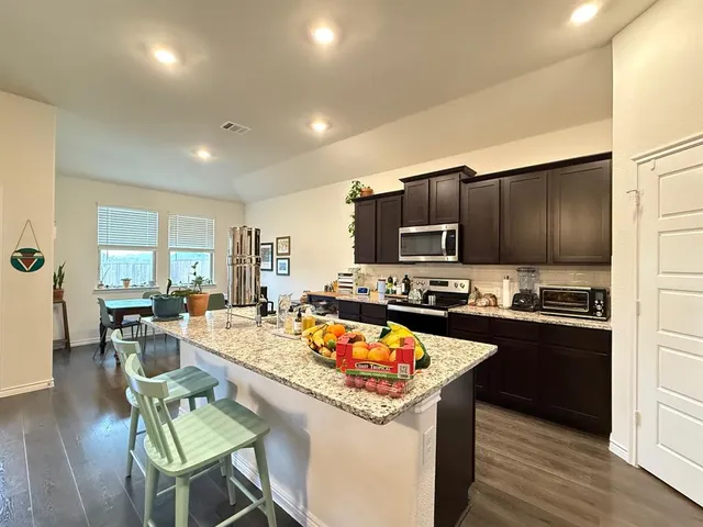 a kitchen with a stove a sink and a refrigerator
