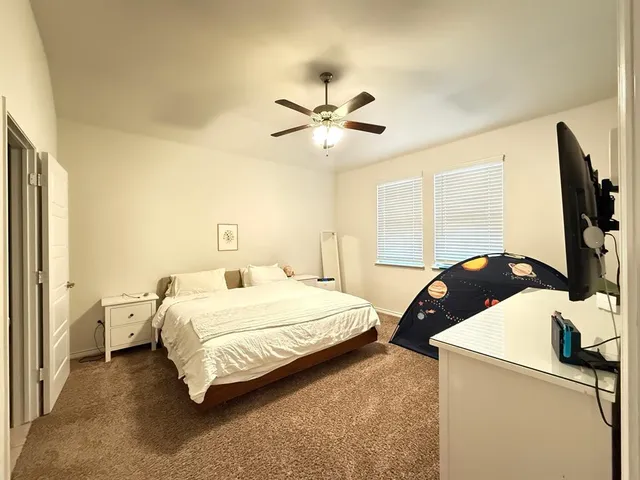 a bedroom with a bed and a flat screen tv