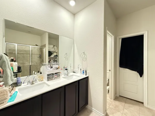 a bathroom with a double vanity sink a and mirror