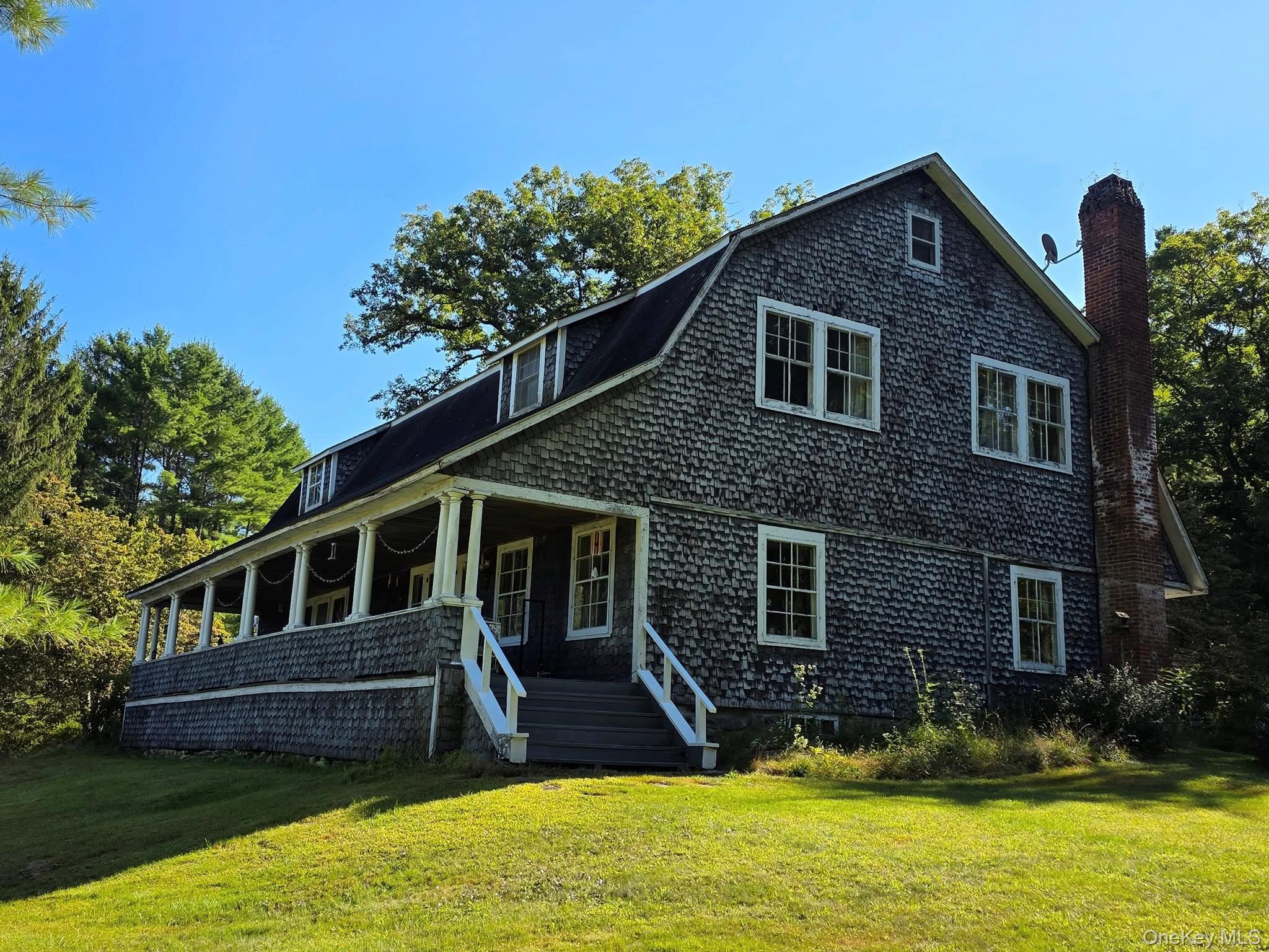 a view of a house with a yard patio and a yard