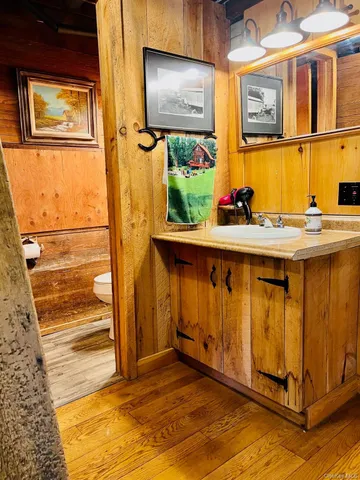 a view of a backyard with table and chairs potted plants and large tree