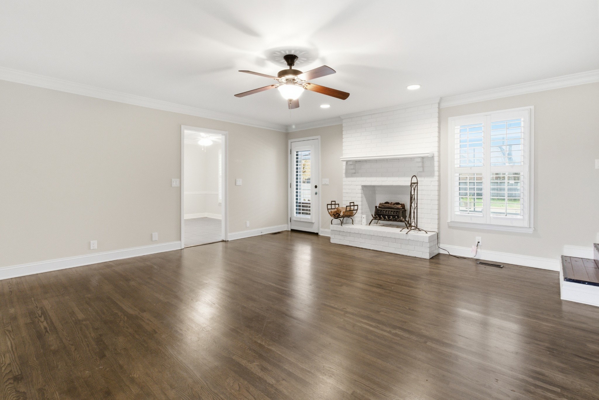 707 Banner Drive Murfreesboro, TN 37129 - Photo 7 of 46 an empty room with wooden floor fireplace and windows
