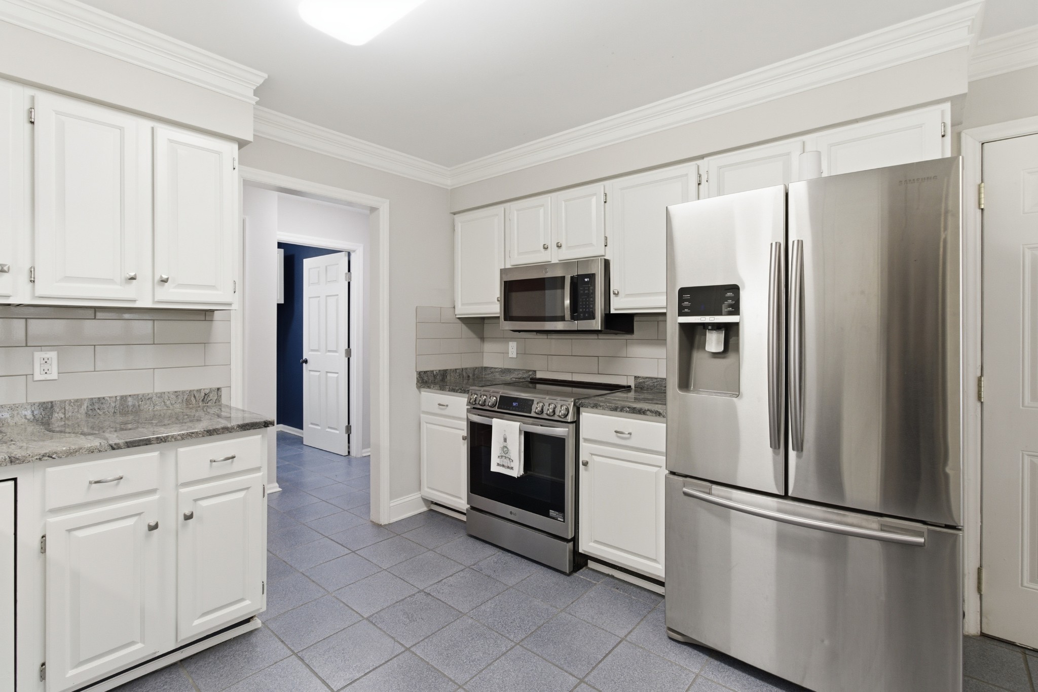 707 Banner Drive Murfreesboro, TN 37129 - Photo 10 of 46 a kitchen with stainless steel appliances granite countertop a refrigerator a stove a sink and white cabinets
