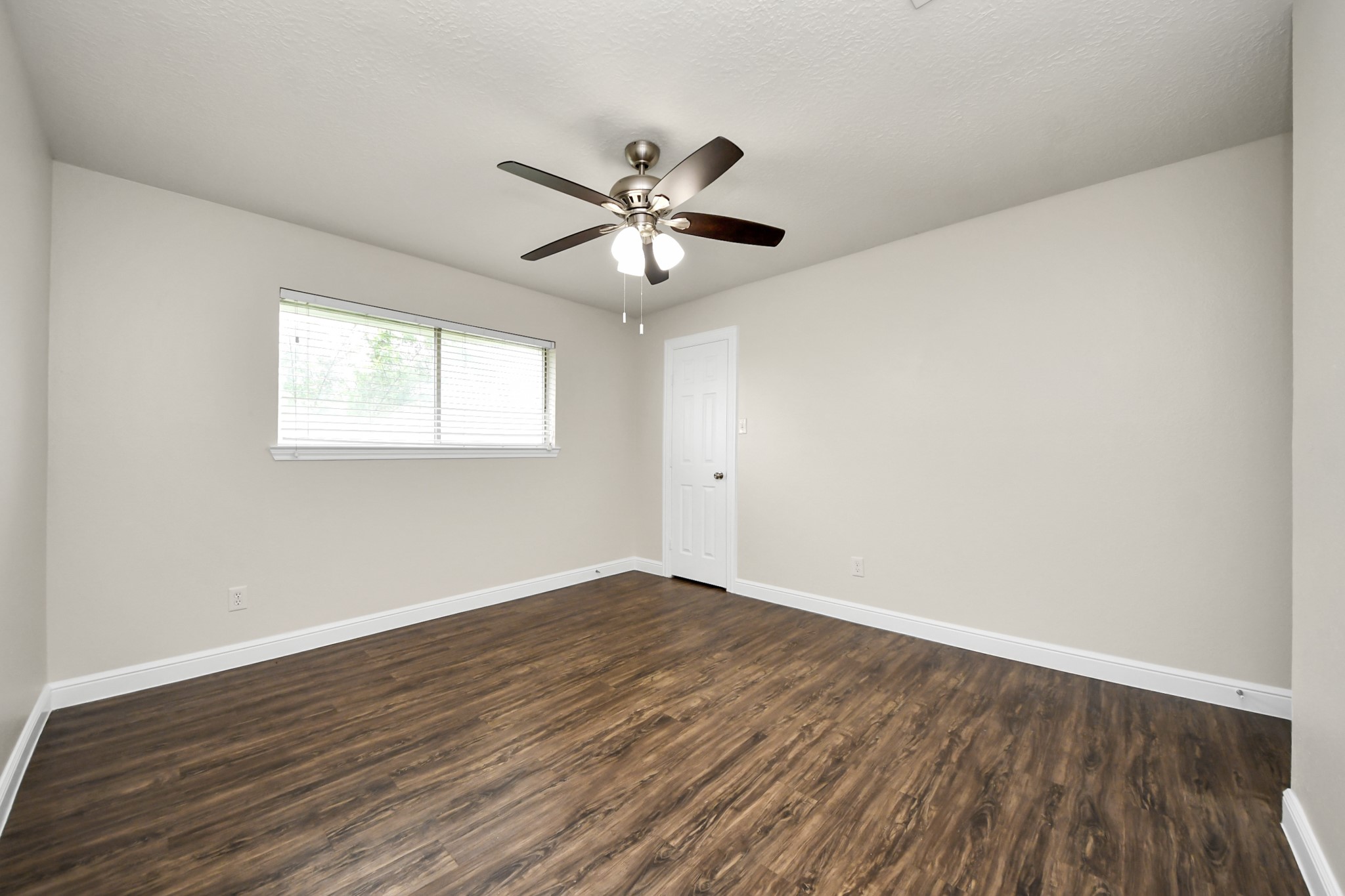 19435 Interstate 45 Spring, TX 77388 - Photo 22 of 24 an empty room with wooden floor ceiling fan and windows