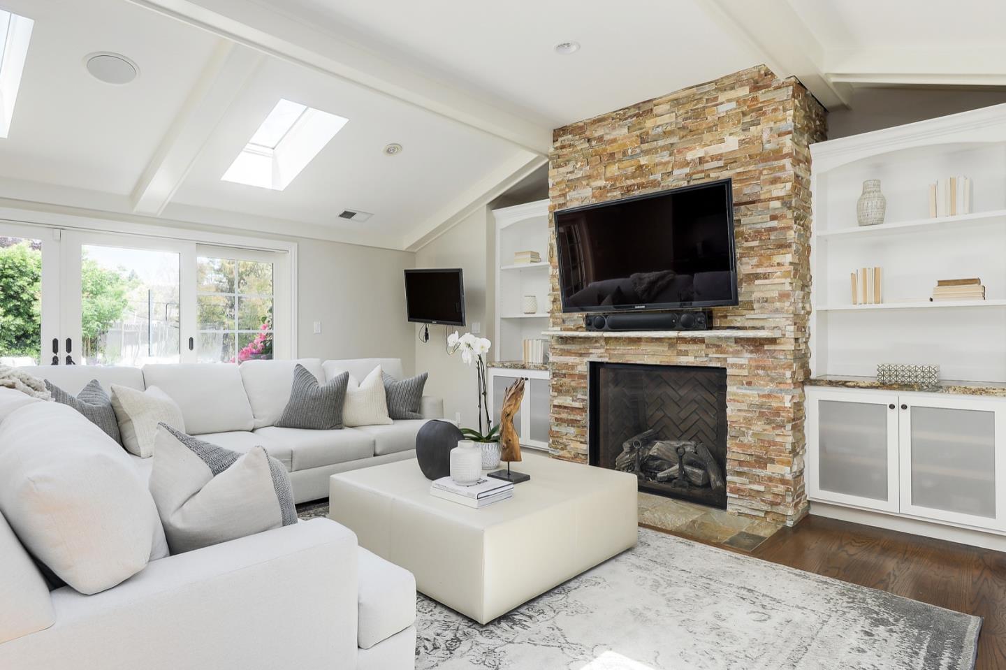 1433 Brookmill Road Los Altos, CA 94024 - Photo 13 of 39 a living room with furniture a fireplace and a flat screen tv