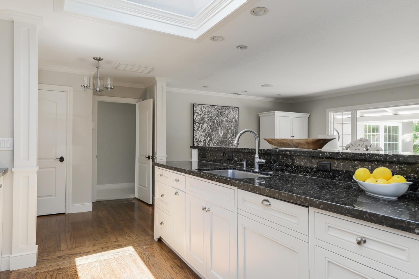 1433 Brookmill Road Los Altos, CA 94024 - Photo 17 of 39 a spacious bathroom with double vanity sinks a vanity a lamp and a mirror
