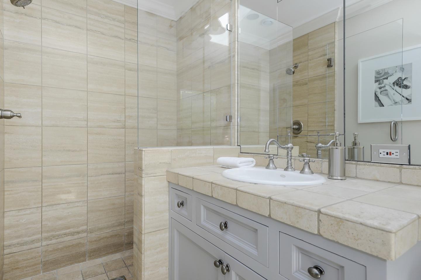 1433 Brookmill Road Los Altos, CA 94024 - Photo 27 of 39 a bathroom with a granite countertop sink a mirror and shower