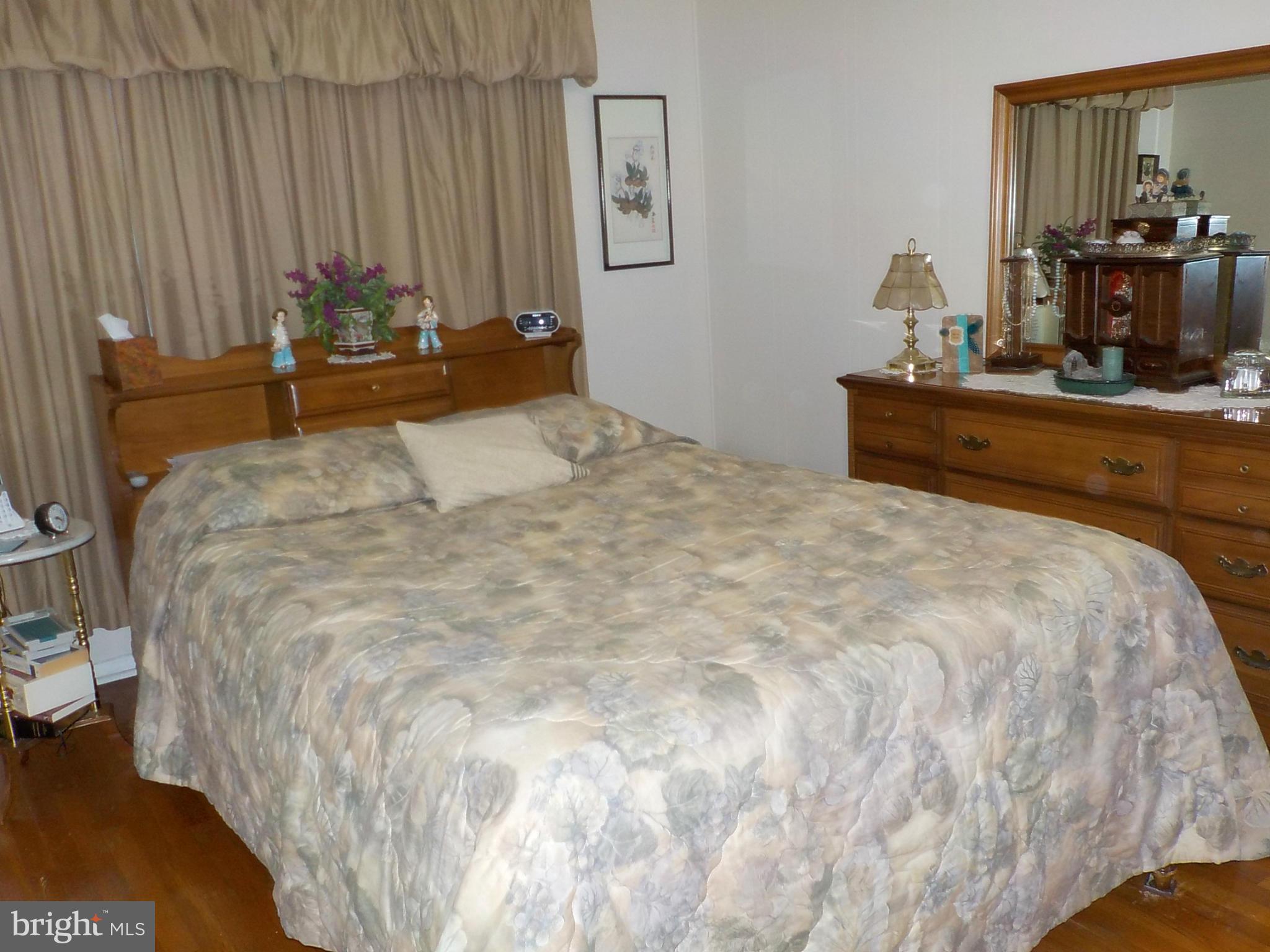 944 Middleborough Road Baltimore, MD 21221 - Photo 11 of 30 a bedroom with a bed and dresser with mirror