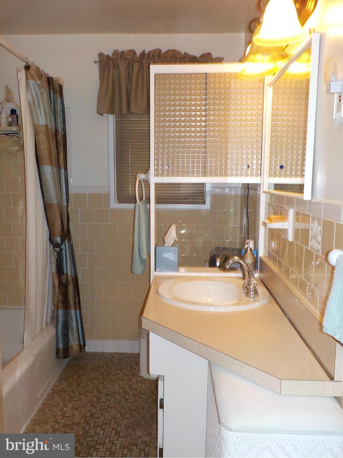 944 Middleborough Road Baltimore, MD 21221 - Photo 16 of 30 a bathroom with a sink and a shower