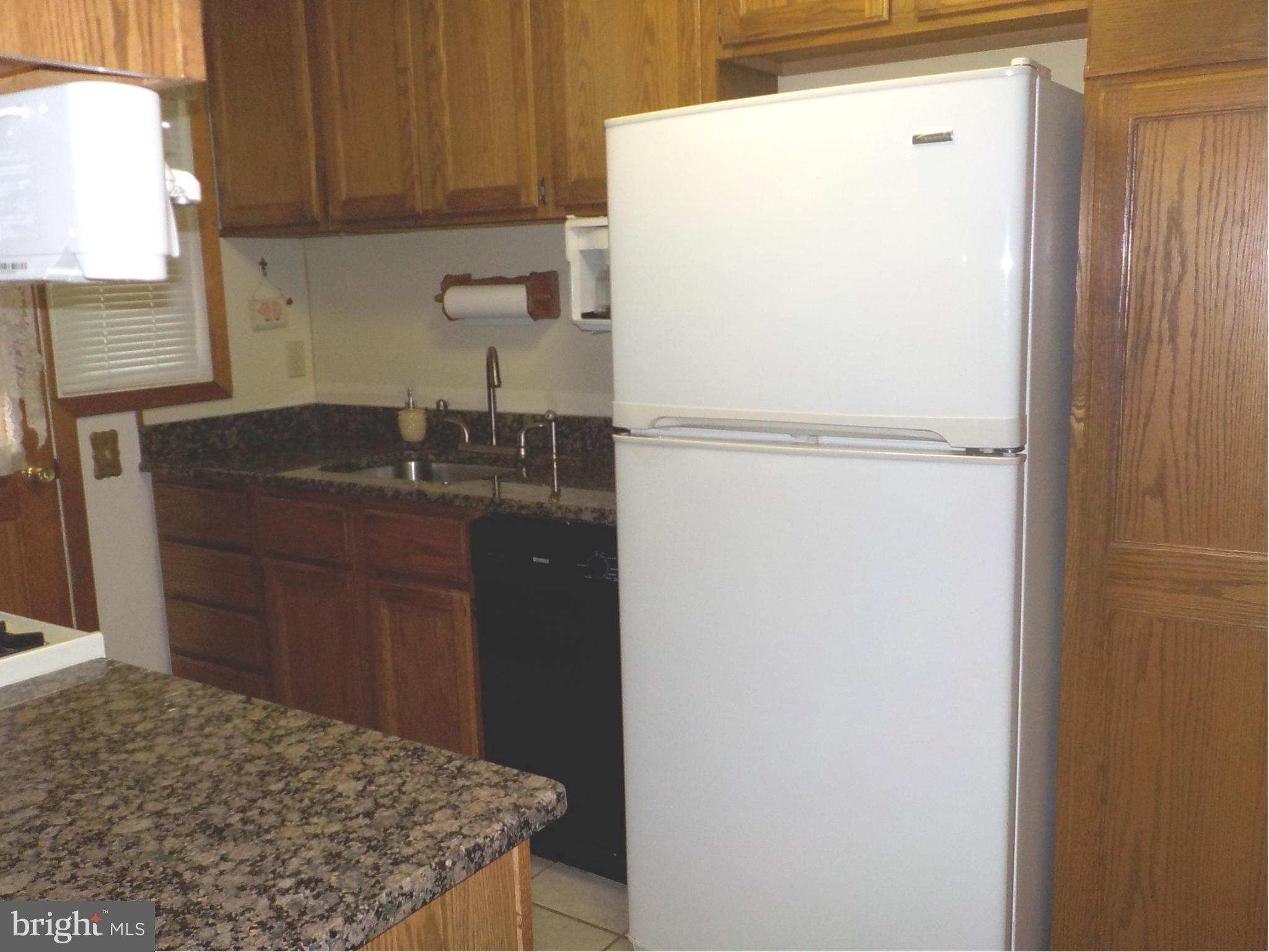 944 Middleborough Road Baltimore, MD 21221 - Photo 7 of 30 a kitchen with a refrigerator and a sink