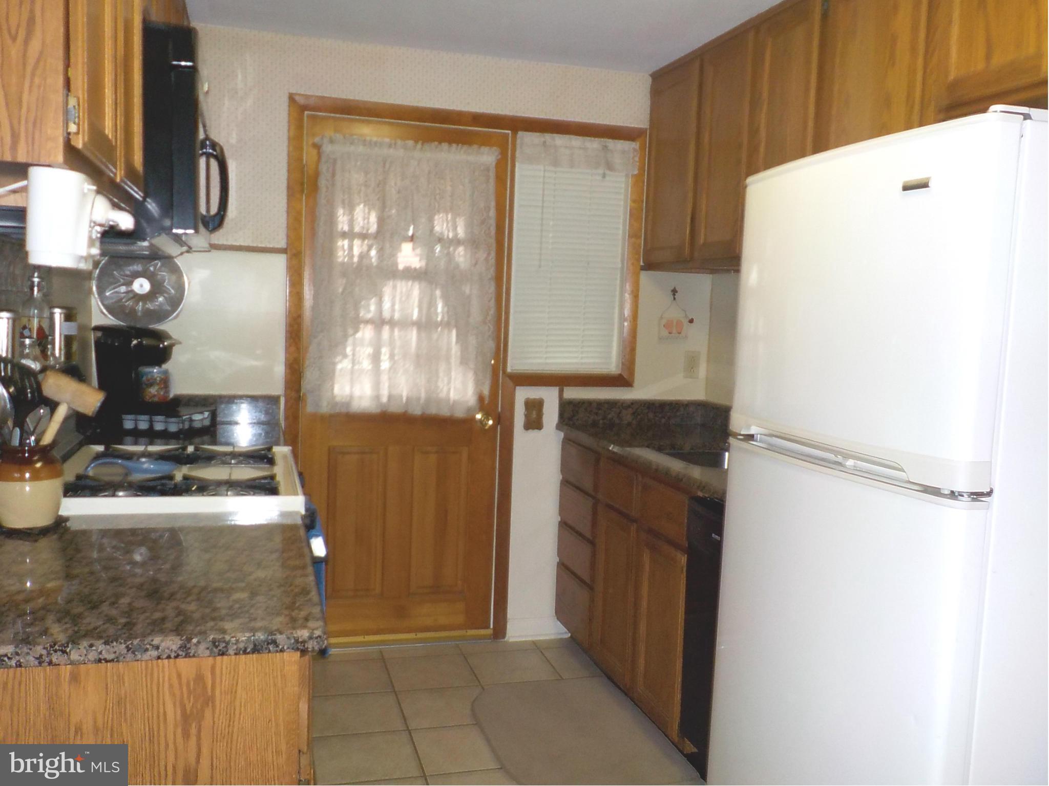 944 Middleborough Road Baltimore, MD 21221 - Photo 8 of 30 a kitchen with a refrigerator and a sink
