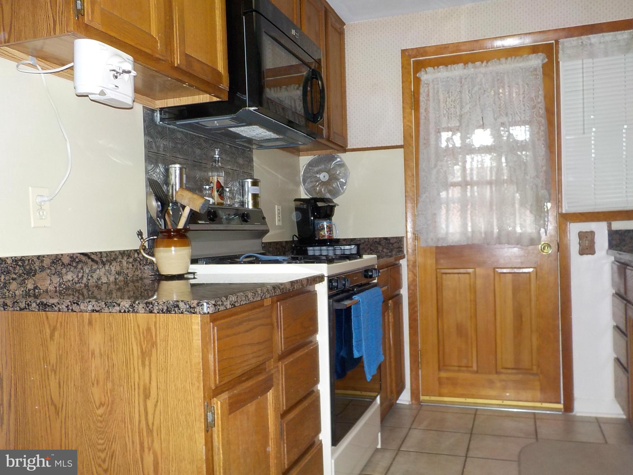 944 Middleborough Road Baltimore, MD 21221 - Photo 9 of 30 a kitchen with stainless steel appliances granite countertop a sink and a cabinets