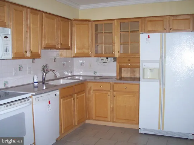 a kitchen with stainless steel appliances granite countertop a refrigerator sink and cabinets