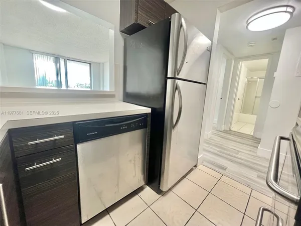 a kitchen with a refrigerator and a stove