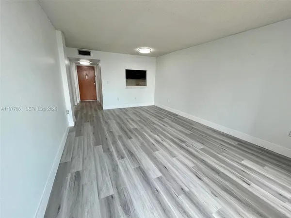 a view of wooden floor and brick walls