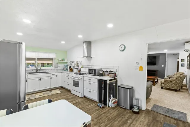 a kitchen with a sink stove and wooden cabinets