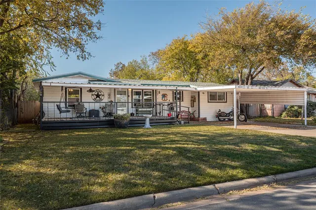 a view of a house with swimming pool and a yard