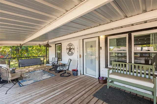 a living room with patio furniture and a floor to ceiling window