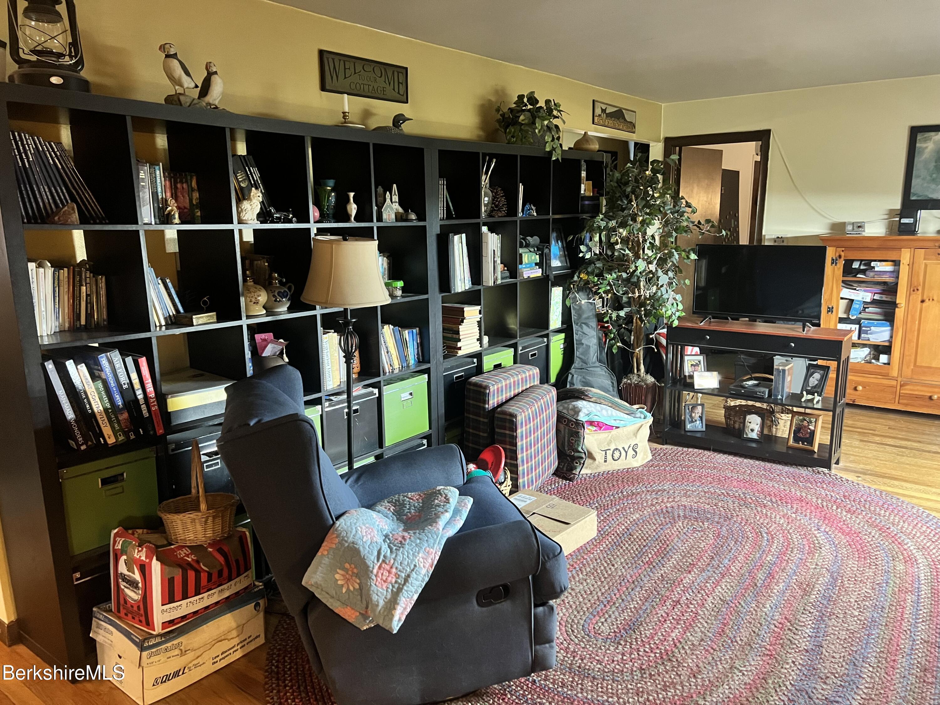 82 River Road Savoy, MA 01256 - Photo 8 of 27 a bedroom with furniture and a flat screen tv