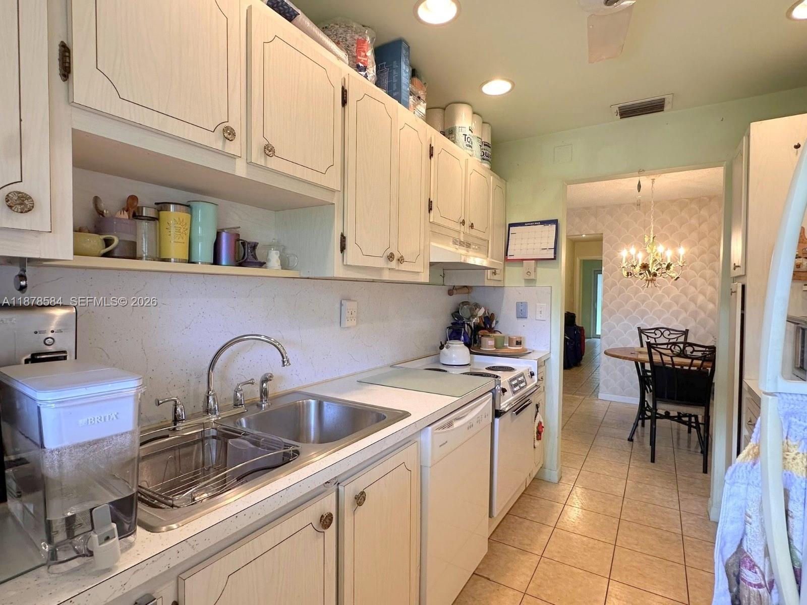 285 North High Point, Unit A Boynton Beach, FL 33435 - Photo 12 of 32 a kitchen with a sink cabinets and appliances
