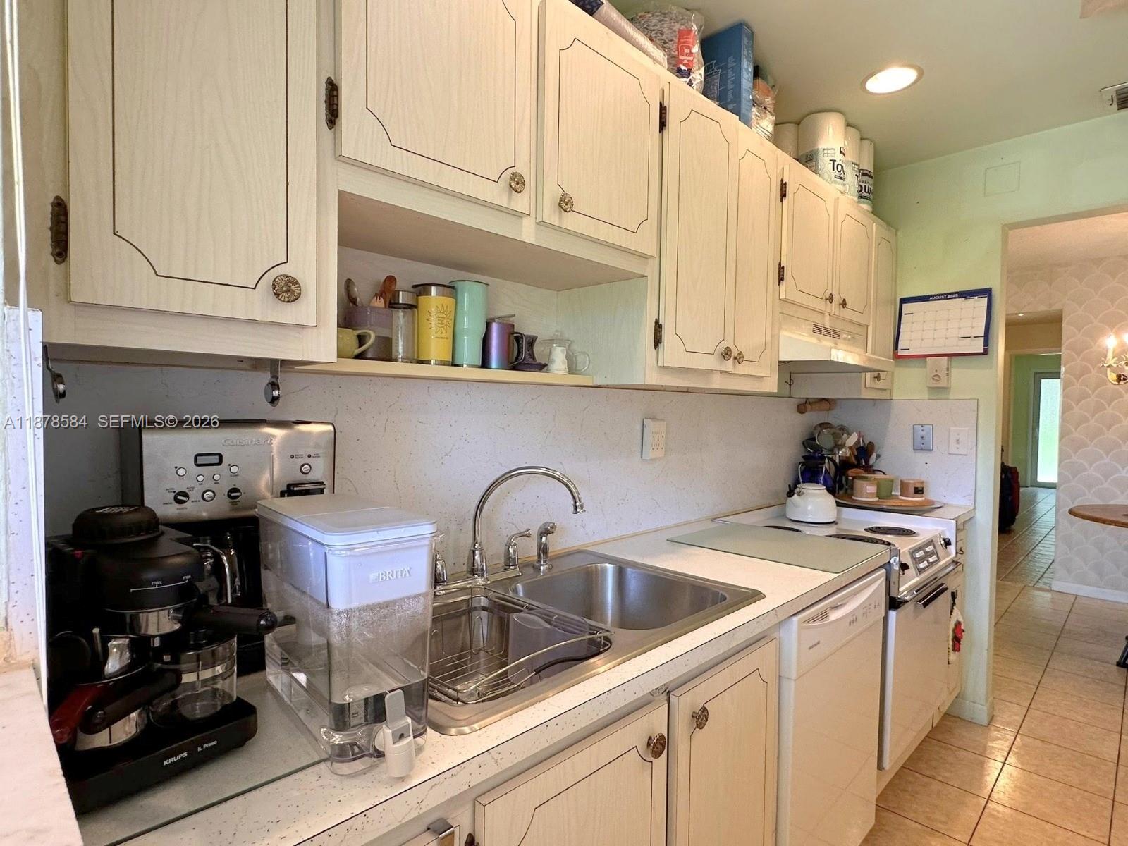 285 North High Point, Unit A Boynton Beach, FL 33435 - Photo 13 of 32 a kitchen with stainless steel appliances granite countertop a sink a stove and cabinets