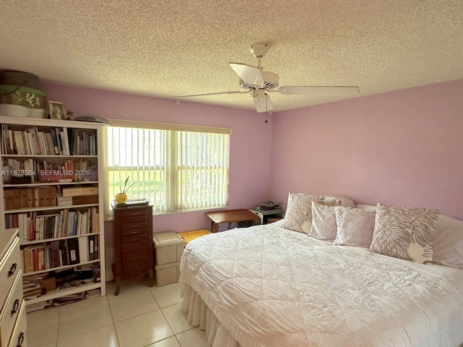 285 North High Point, Unit A Boynton Beach, FL 33435 - Photo 16 of 32 a bedroom with a large bed and a window